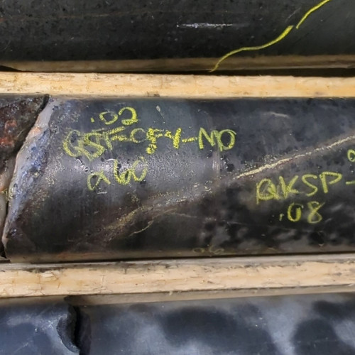 0.65% Cu, 0.03 g/t Au, 2.8 g/t Ag, 0.19% Mo from 243.93m to 244.28m